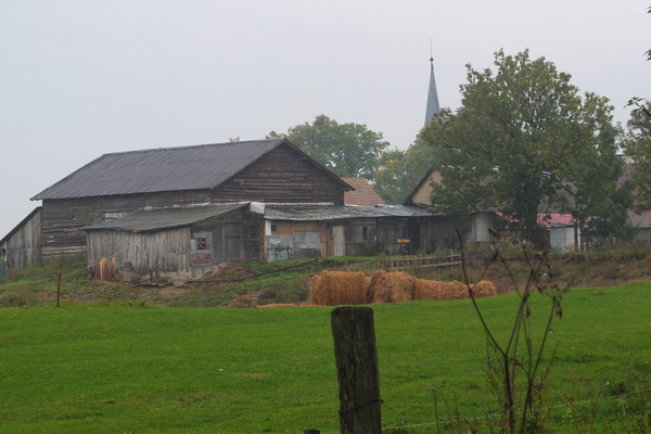 Schimonken, Landstraßenseite links, man sieht auch schon die Kirchturmspitze